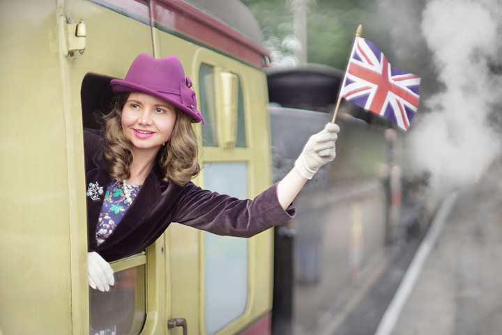 1940s girl waves British flag out of train